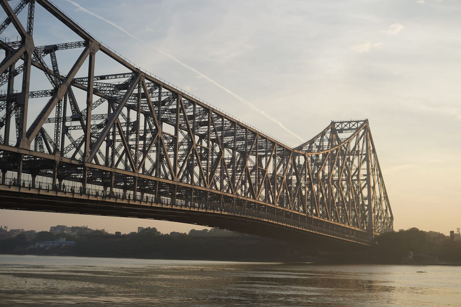 The Howrah Bridge over the Hooghly River in Kolkata at sunrise