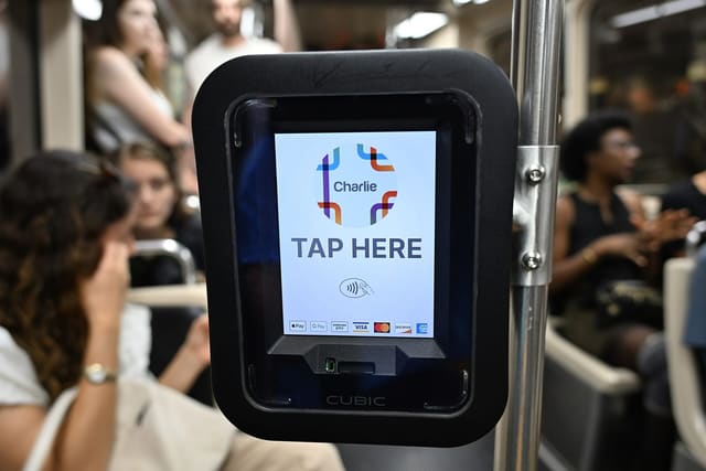 A tap-to-pay fare reader on a train
