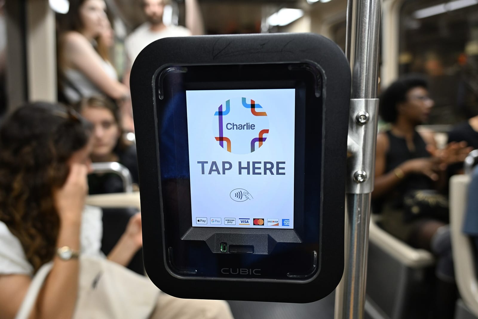 A tap-to-pay fare reader on a train