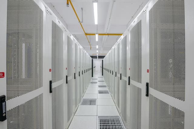A corridor between server racks in a data centre