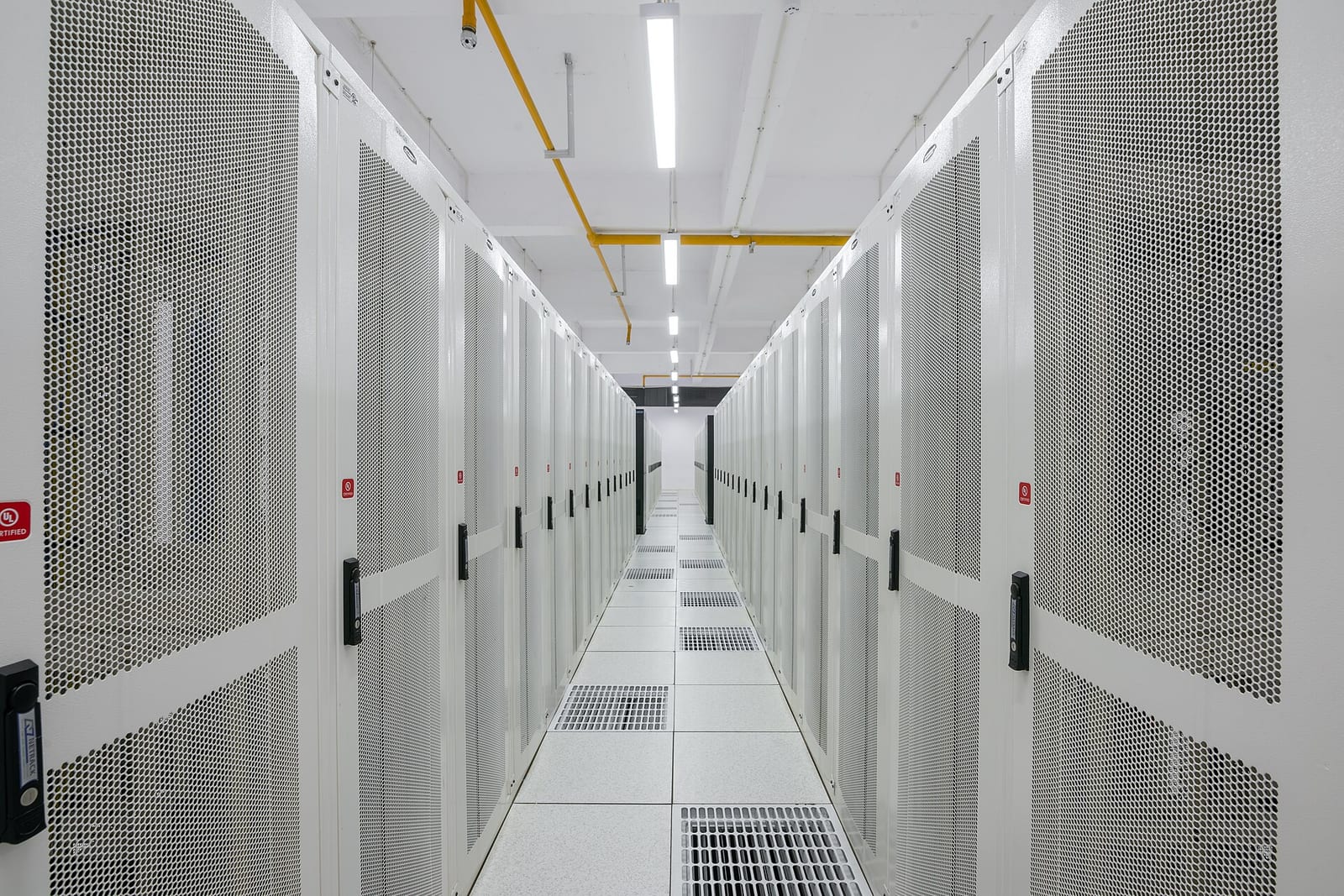 A corridor between server racks in a data centre