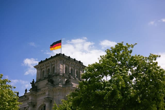The Reichstag in Berlin with the German flag on its roof
