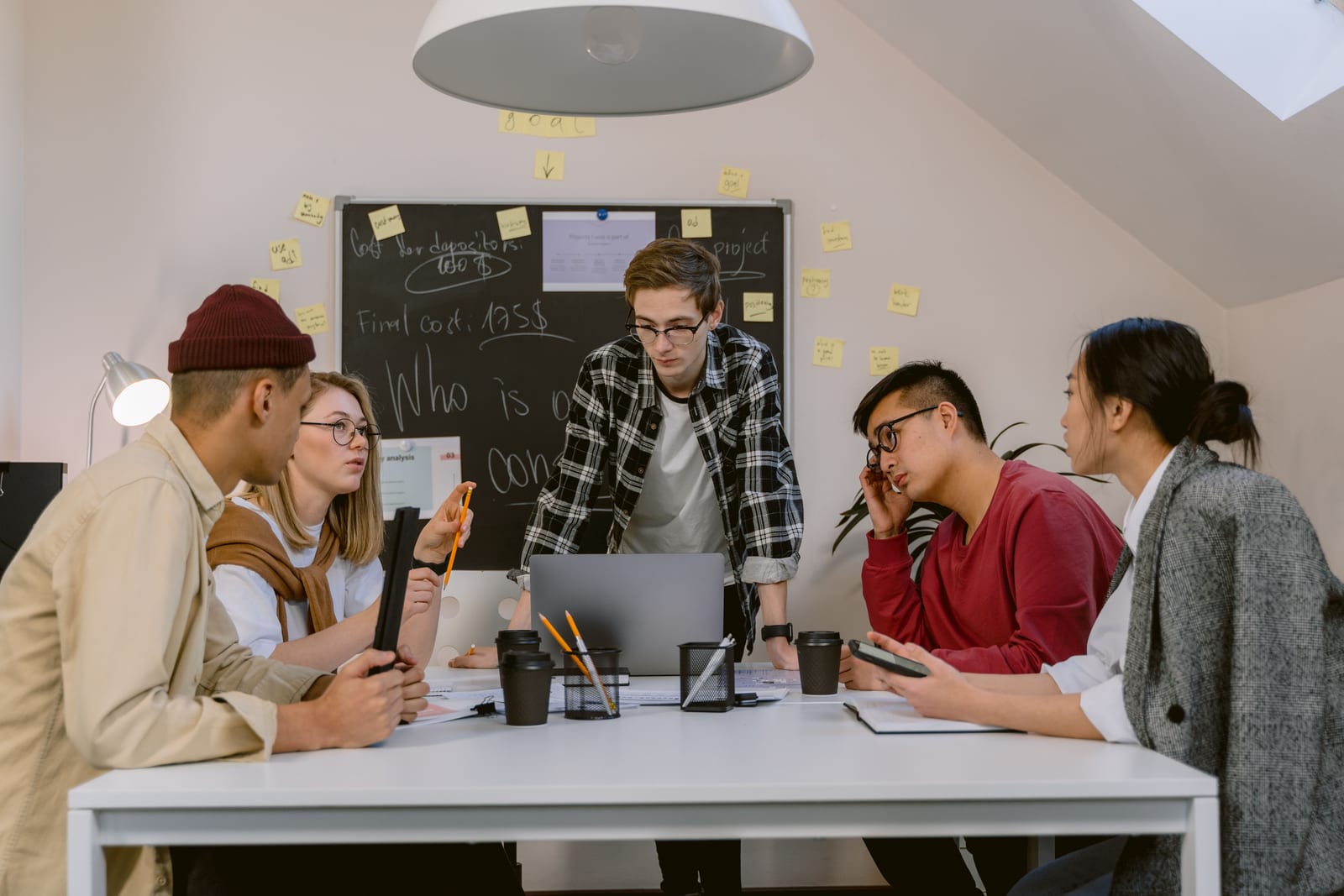 A small team working around a table with laptops and notes