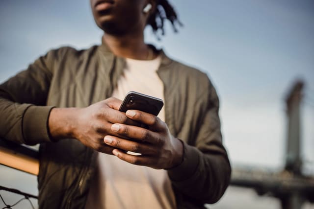A man holding a smartphone in both hands
