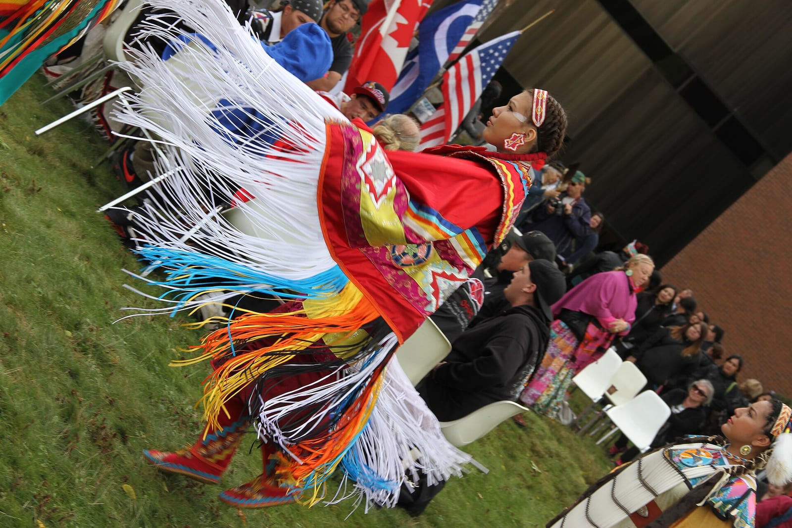 A dancer in regalia at a powwow