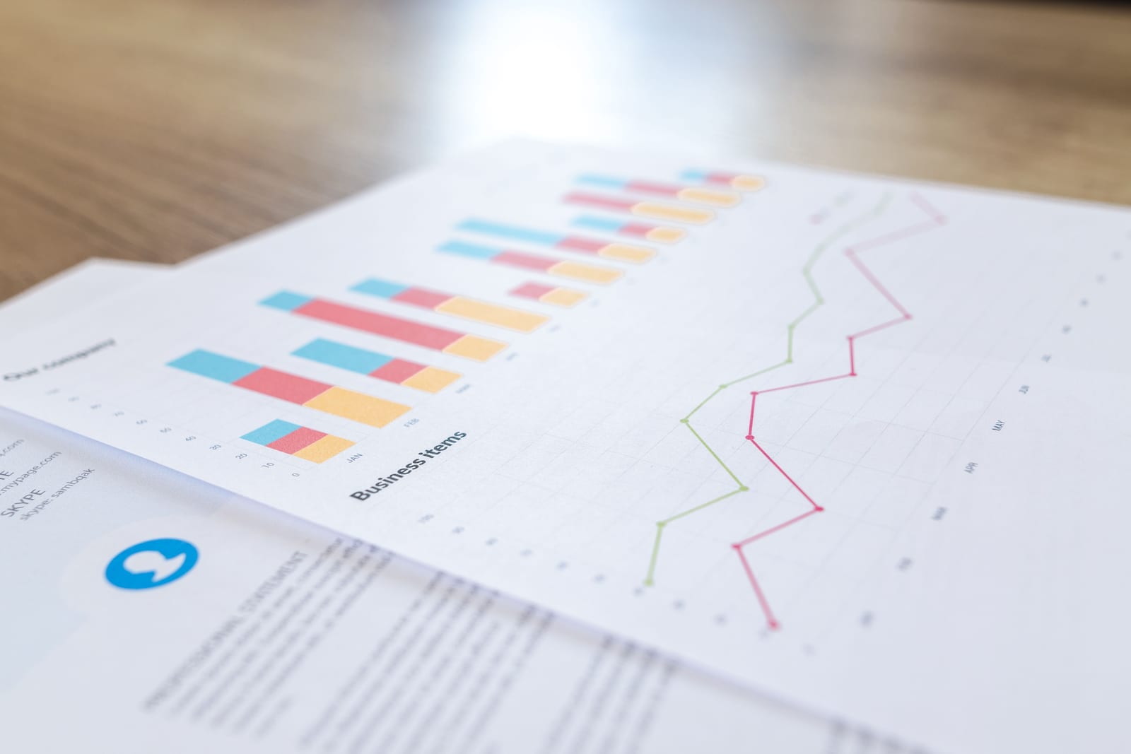 Printed bar and line charts on a desk