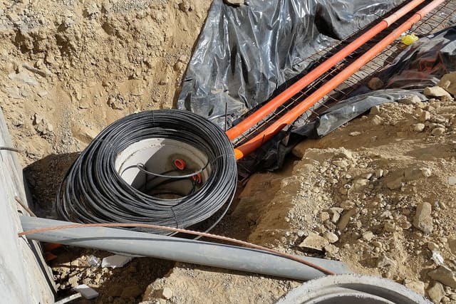 Workers installing fibre optic cable