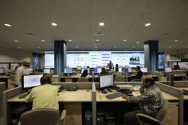 Staff at screens in a network operations centre