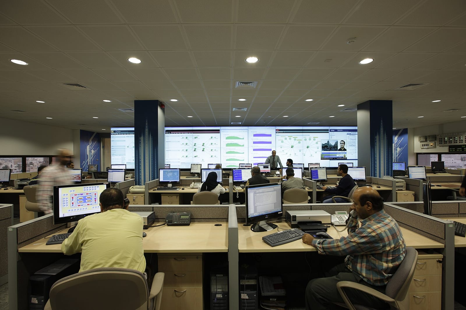 Staff at screens in a network operations centre