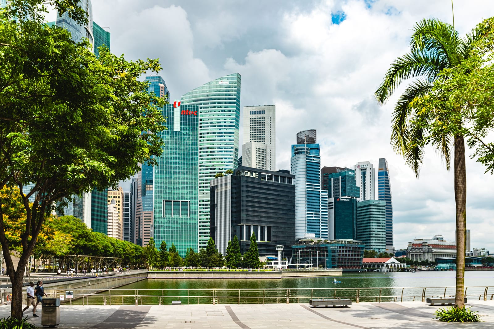 Singapore's financial district seen across the water from a waterfront promenade