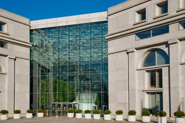 The glass atrium entrance of the Thurgood Marshall Federal Judiciary Building in Washington